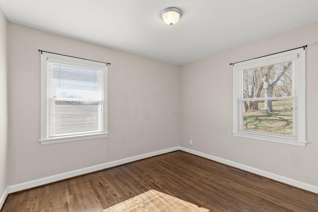 empty room featuring dark wood-type flooring