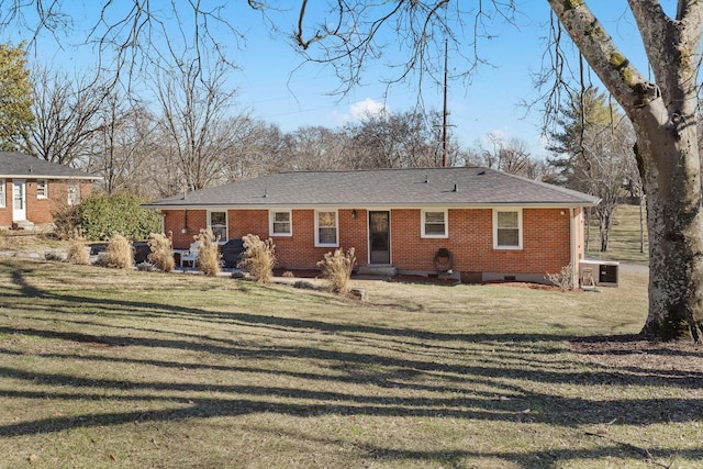 rear view of house featuring a lawn