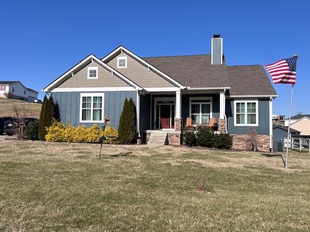 craftsman-style house with covered porch and a front yard