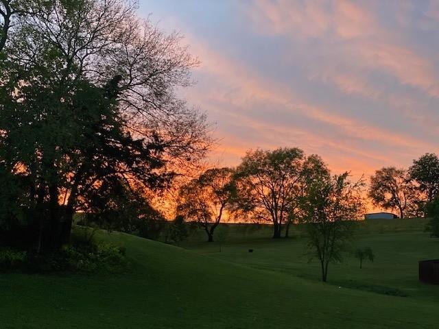 view of property's community with a lawn