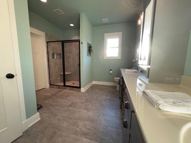 bathroom featuring vanity, an enclosed shower, and toilet