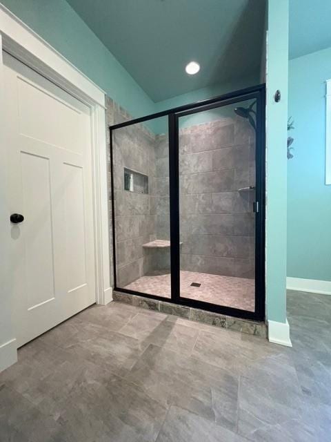 bathroom with a shower with shower door