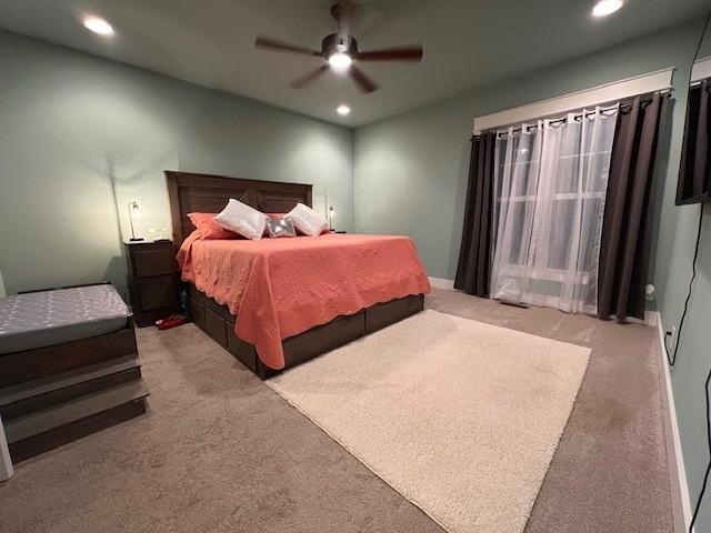 bedroom featuring light carpet and ceiling fan