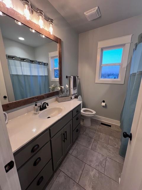 bathroom with vanity, tile patterned floors, and toilet