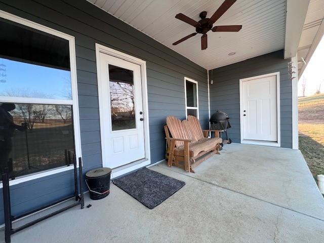 property entrance with ceiling fan and a patio area