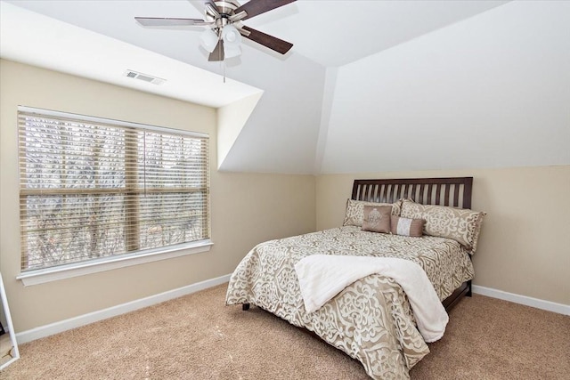 carpeted bedroom with ceiling fan and vaulted ceiling