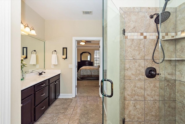 bathroom featuring vanity, tile patterned floors, and a shower with shower door