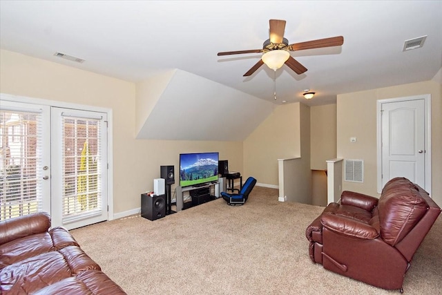 living room featuring french doors, ceiling fan, lofted ceiling, and light carpet