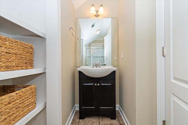 bathroom featuring vanity, tile patterned floors, and a shower with shower door