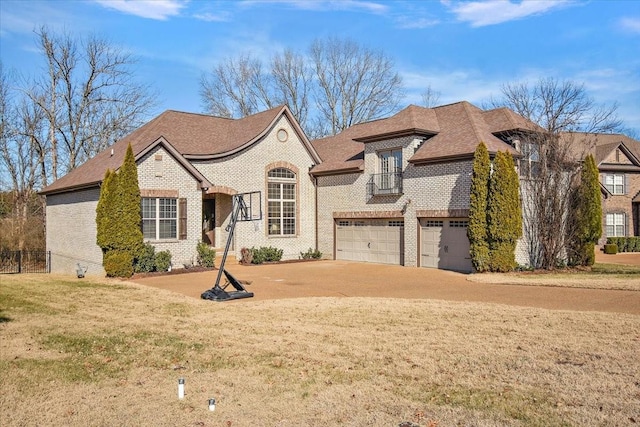 view of front of property featuring a garage and a front lawn