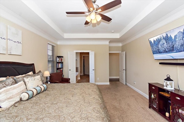 carpeted bedroom featuring a raised ceiling and ceiling fan