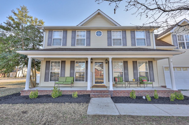 view of front of property with a garage and covered porch