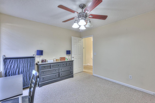 carpeted bedroom featuring a textured ceiling and ceiling fan