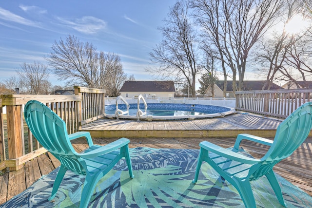 wooden terrace with a fenced in pool