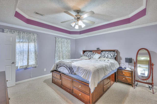 bedroom with light carpet, crown molding, a raised ceiling, and a textured ceiling