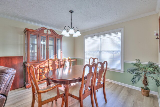 dining area with crown molding, light hardwood / wood-style flooring, a textured ceiling, and a chandelier