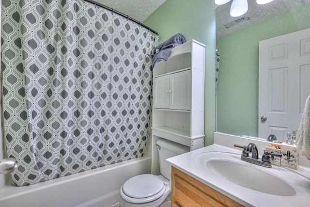 full bathroom with shower / bath combination with curtain, vanity, toilet, and a textured ceiling