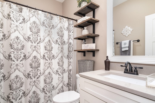 bathroom featuring vanity, toilet, and a shower with shower curtain