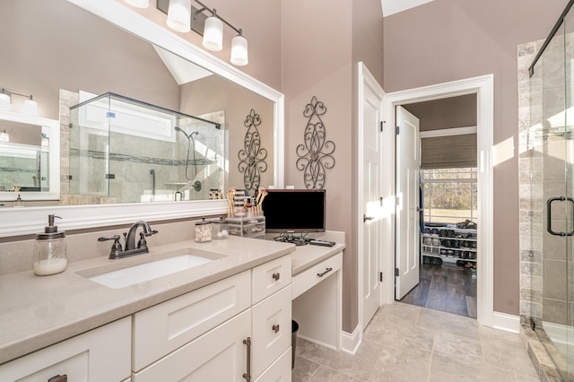 bathroom with vanity, vaulted ceiling, and walk in shower