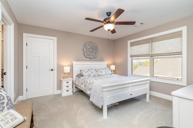 bedroom featuring light colored carpet and ceiling fan