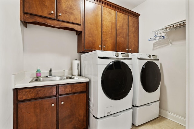 laundry room with cabinets, sink, light tile patterned floors, and independent washer and dryer