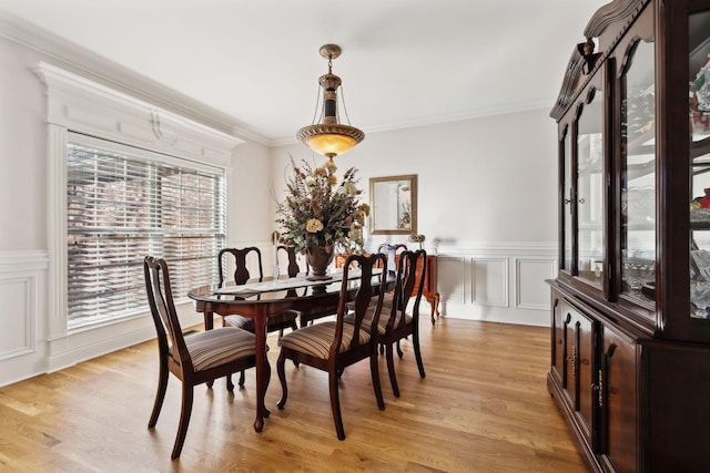 dining room featuring crown molding and light wood-type flooring