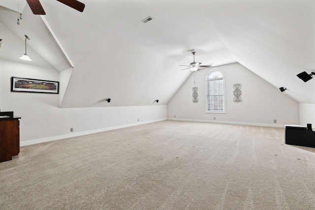 bonus room with lofted ceiling, light carpet, and ceiling fan