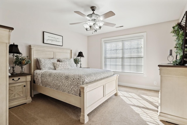 bedroom with light colored carpet and ceiling fan