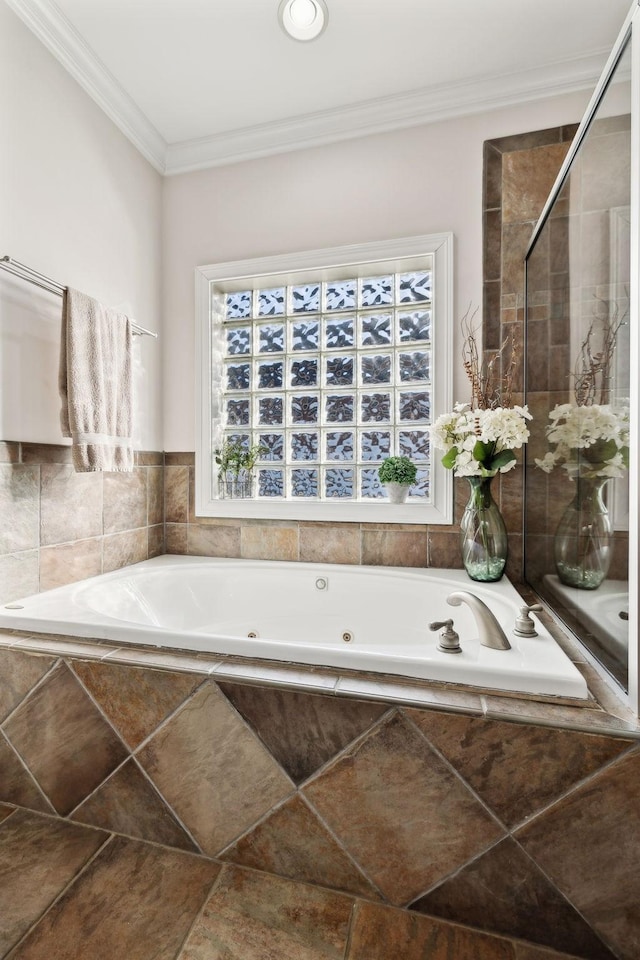 bathroom featuring crown molding and separate shower and tub