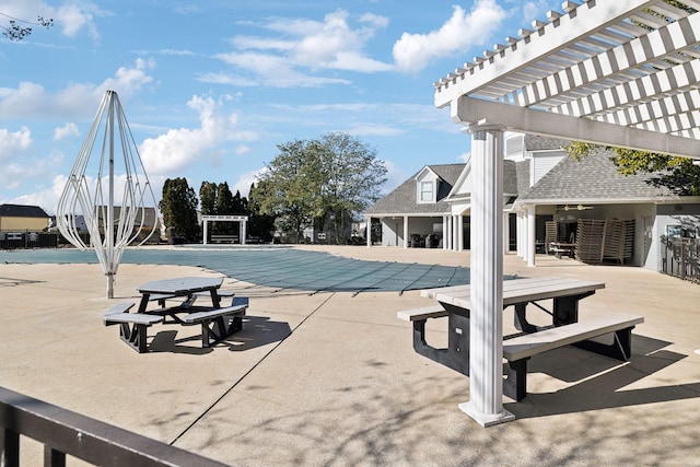 view of swimming pool with a patio and a pergola