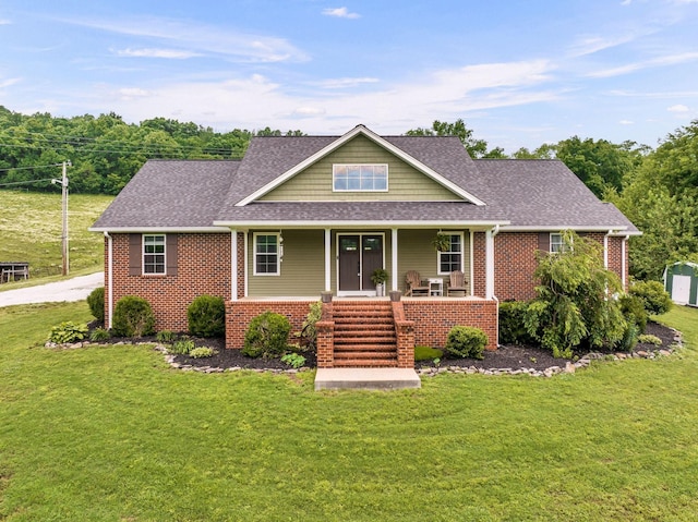 view of front of property featuring a front yard and covered porch