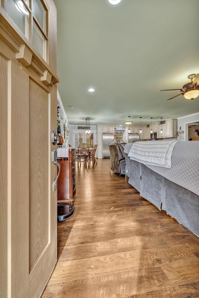 interior space with hardwood / wood-style flooring and stainless steel built in refrigerator