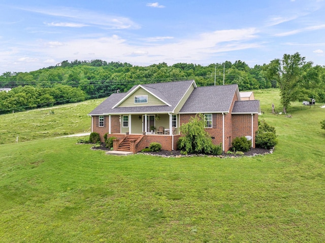 view of front of home featuring covered porch and a front lawn