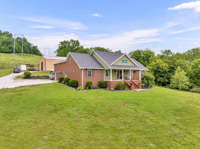 view of front of home with a garage, a front lawn, and covered porch