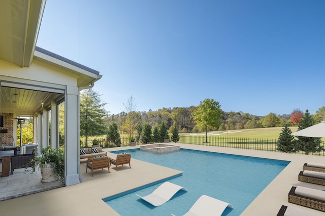 view of swimming pool featuring a patio area and an in ground hot tub