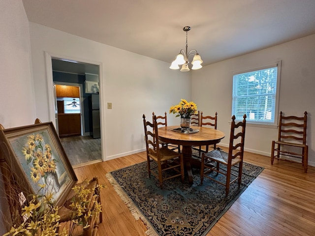 dining room featuring wood-type flooring and a notable chandelier