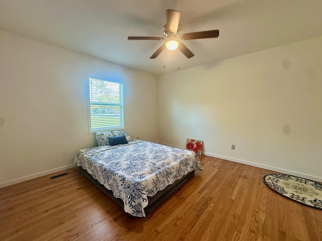 bedroom with wood-type flooring and ceiling fan