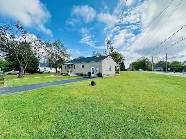 view of side of home featuring a yard