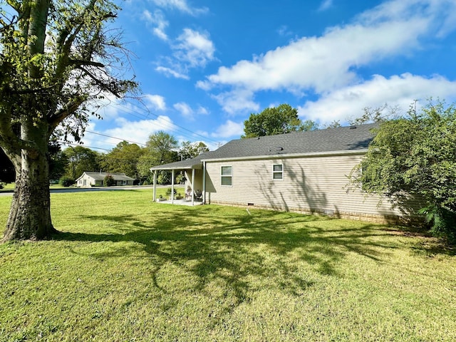 rear view of house with a lawn and a patio