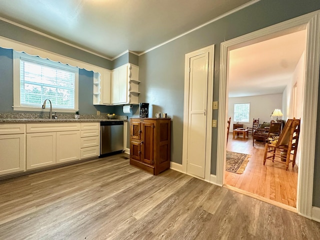 kitchen featuring white cabinetry, crown molding, stainless steel dishwasher, stone counters, and light hardwood / wood-style floors