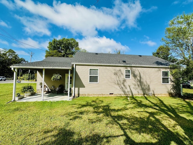 back of property with a patio area and a lawn