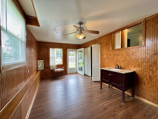 unfurnished room featuring hardwood / wood-style flooring, ceiling fan, and sink