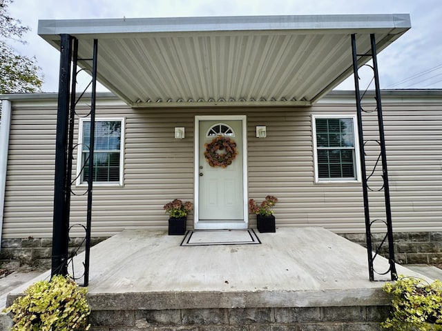 property entrance featuring a patio area