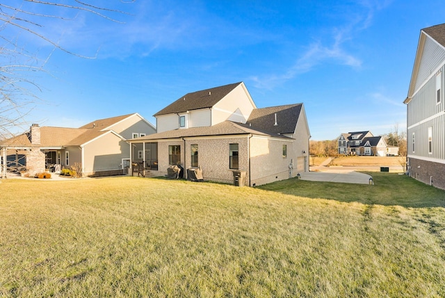 rear view of property with a lawn