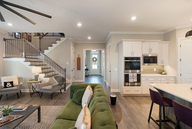 living room with hardwood / wood-style flooring and ornamental molding