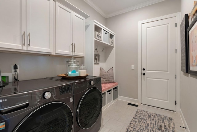 laundry area featuring crown molding, cabinets, light tile patterned flooring, and washing machine and dryer