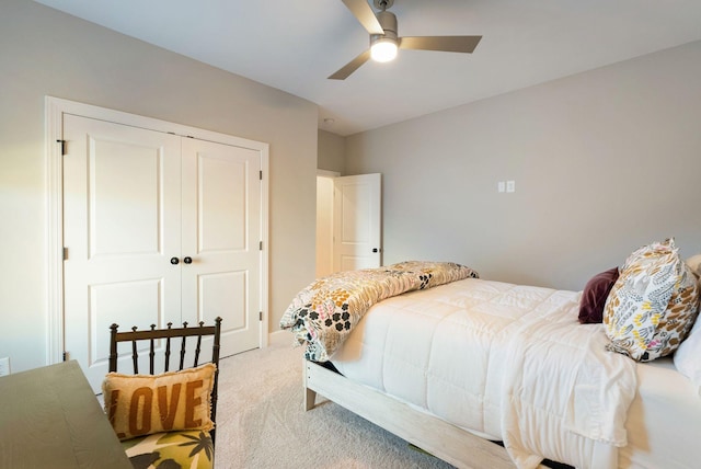 bedroom with light colored carpet, a closet, and ceiling fan