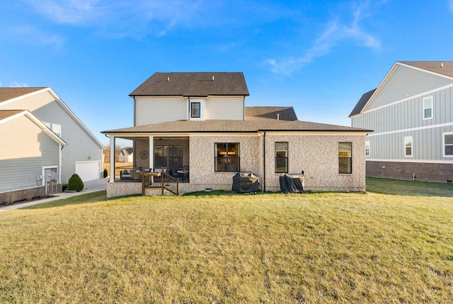 rear view of house featuring a sunroom and a lawn