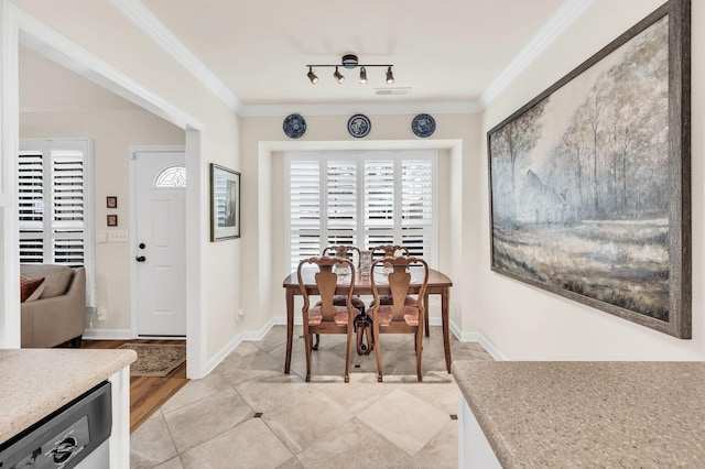 dining area featuring crown molding, rail lighting, and light tile patterned floors