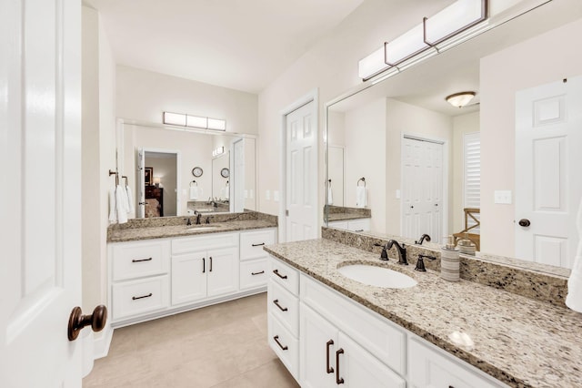 bathroom featuring tile patterned flooring and vanity